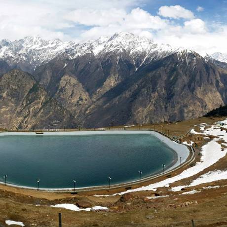 A beautiful view of artificial lake at Auli and snow capped peaks in the backdrop.