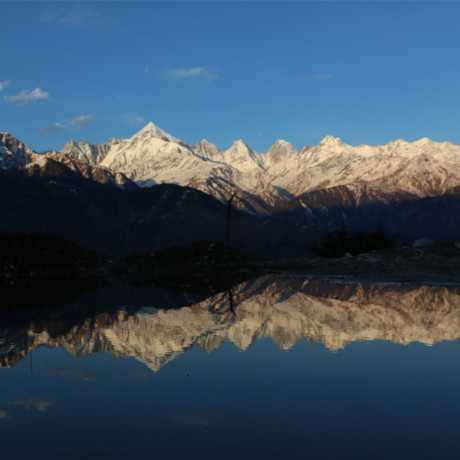 Stunning view of Panchchuli peaks and its beautiful reflection in water.