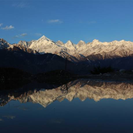Stunning view of Panchchuli peaks and its beautiful reflection in water.